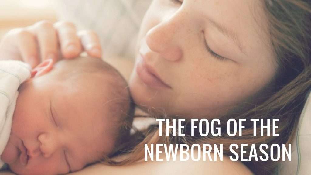 A Portland mother holding her newborn baby to her head in her postpartum