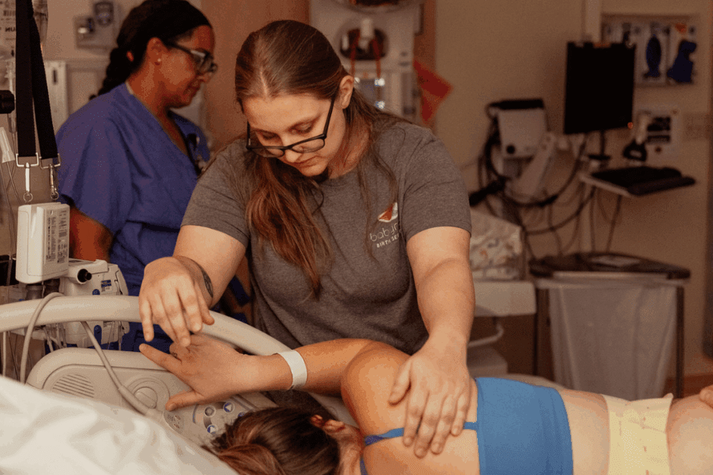 Portland and Baby Nest Doula providing emotional and physical support to a pregnant woman during labor.